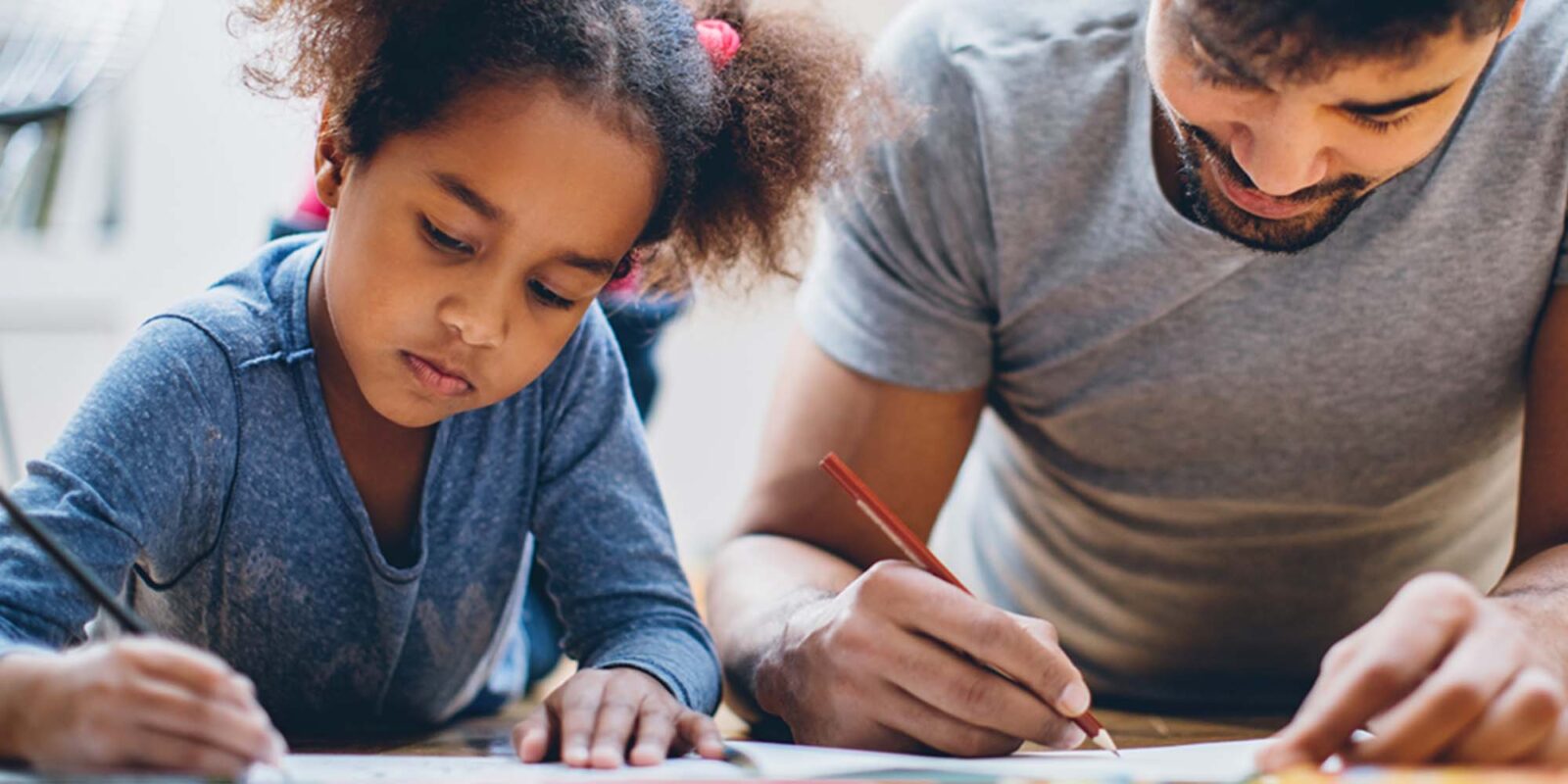 Man and child writing.