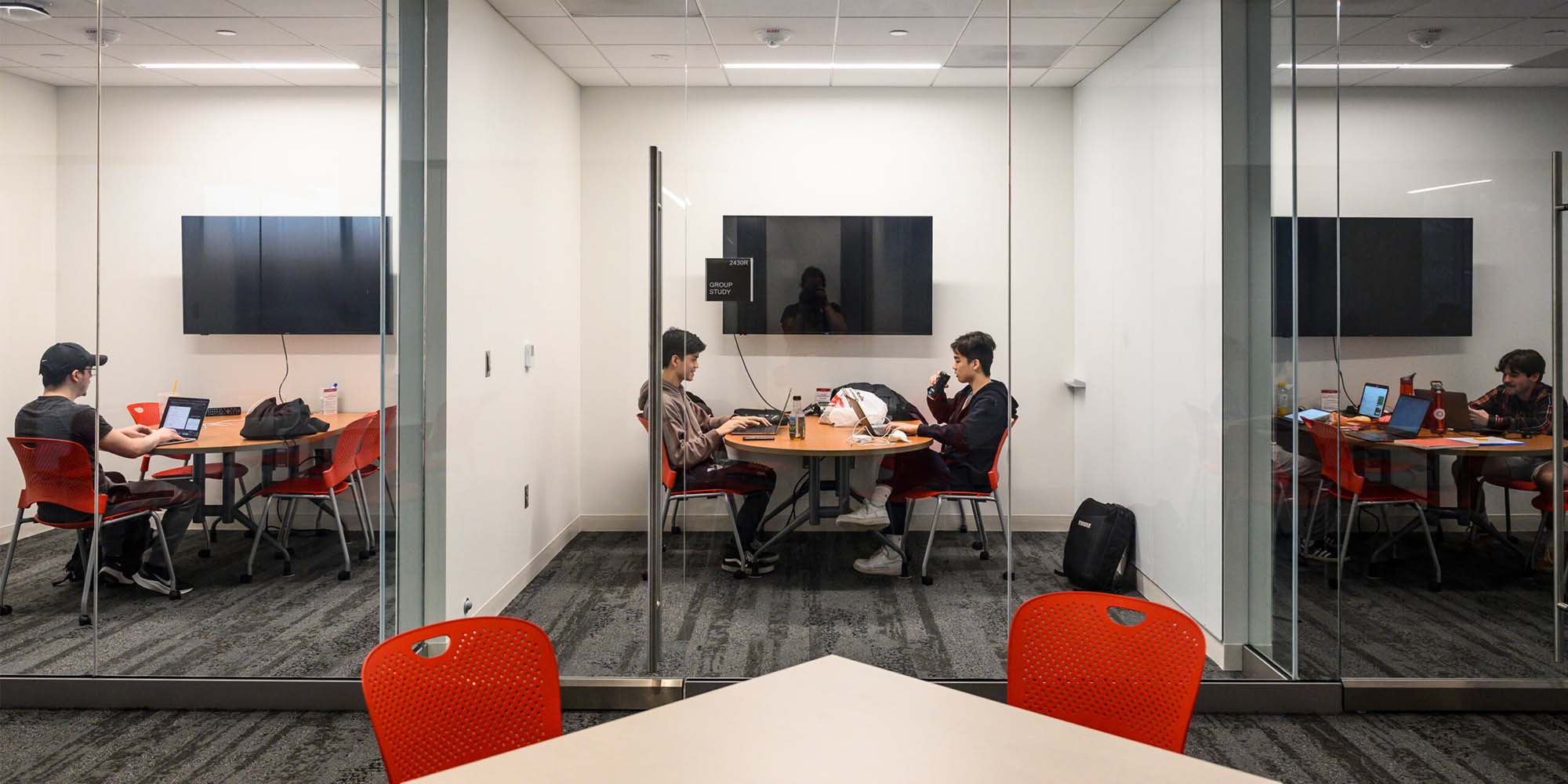 college students in glass study rooms on UW campus